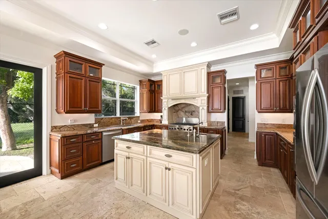 a kitchen with stainless steel appliances granite countertop a sink stove and refrigerator