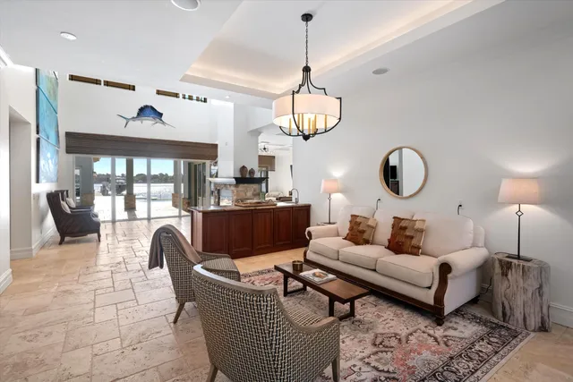 a living room with fireplace furniture and a large window