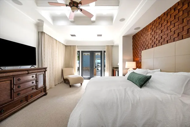 a bedroom with a bed and flat screen tv