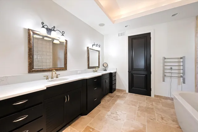 a spacious bathroom with a double vanity sink double and a mirror