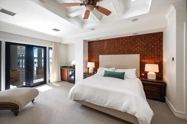 a bedroom with a bed and glass door