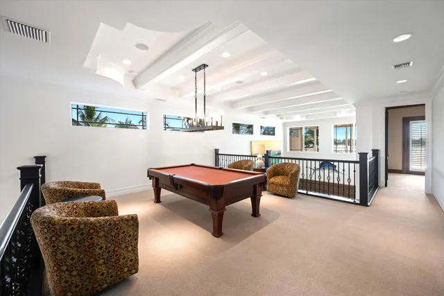 a living room with furniture a ceiling fan and a rug