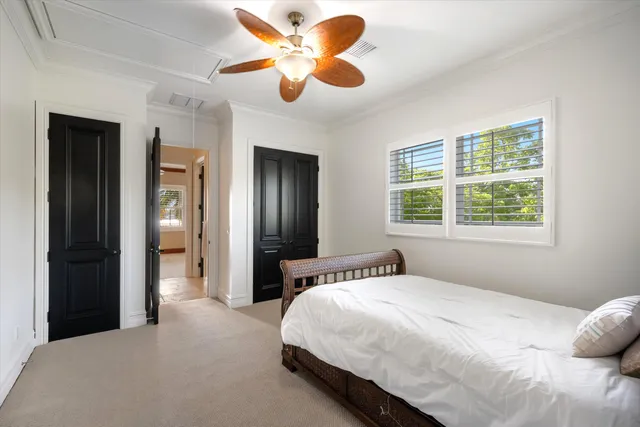 a bedroom with a large bed and a chandelier