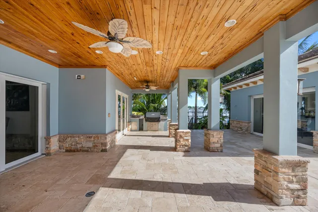 a view of a patio with table and chairs and potted plants