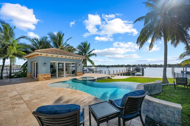a swimming pool with outdoor seating and yard