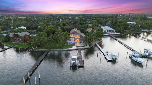 an aerial view of lake and residential houses with outdoor space