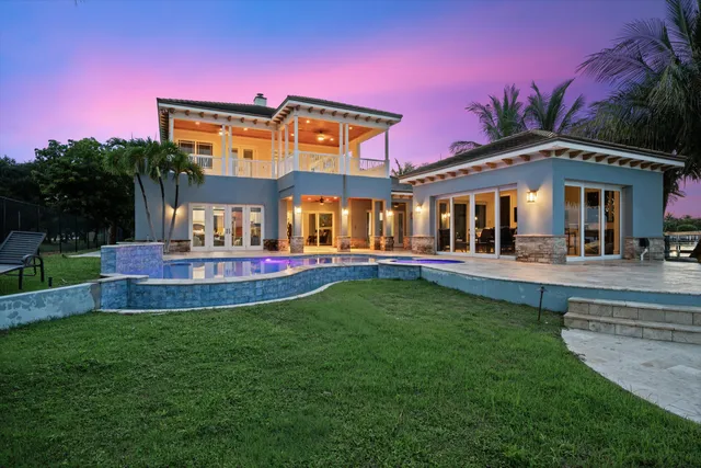 a front view of a house with swimming pool yard and outdoor seating