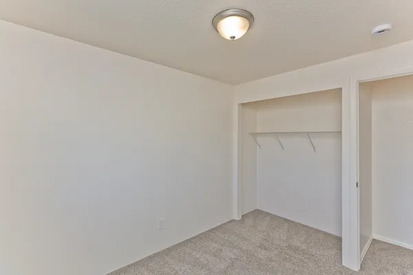 an empty room with closet area