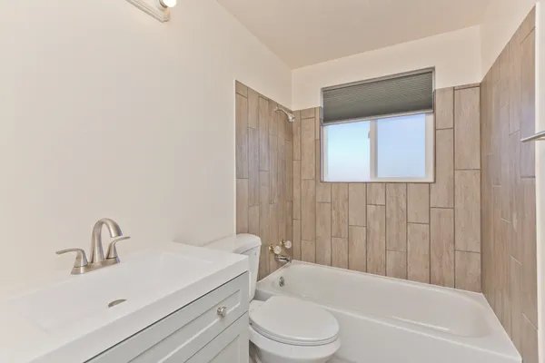 a bathroom with a toilet a sink and bathtub