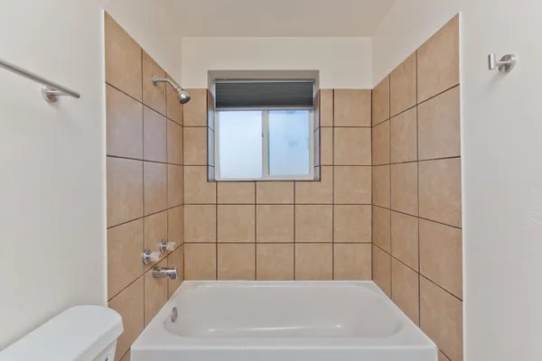 a bathroom with a bathtub and toilet