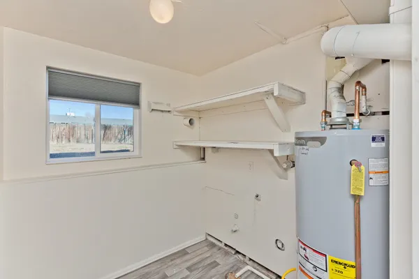a view of storage and utility room with a window