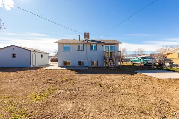 a view of a house with a yard covered in snow