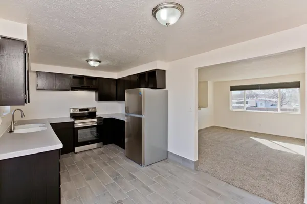 a kitchen with stainless steel appliances a refrigerator stove and sink