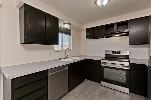 a kitchen with a sink stainless steel appliances and cabinets