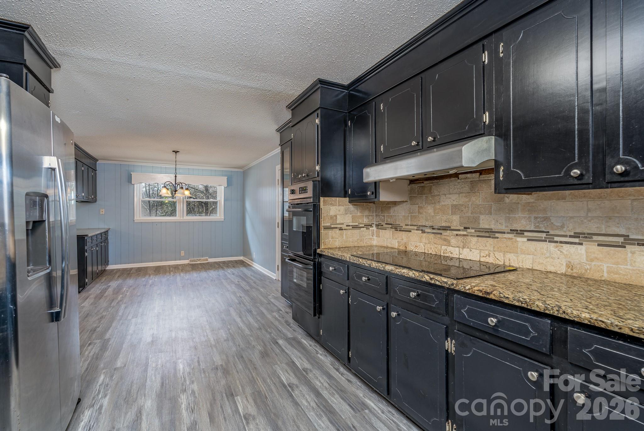 3439 Filbert Highway Clover, SC 29710 - Photo 11 of 28 a kitchen with granite countertop wooden cabinets a sink and stainless steel appliances