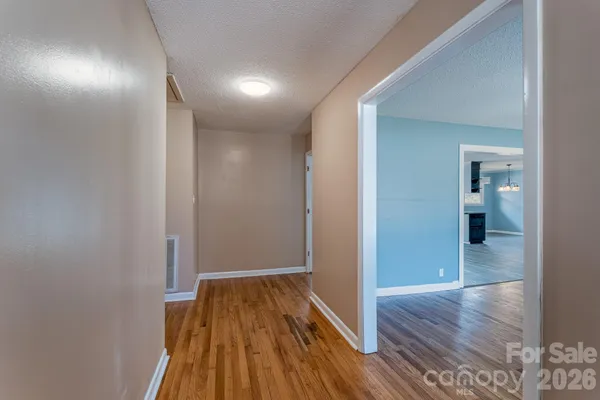 a view of a hallway with wooden floor