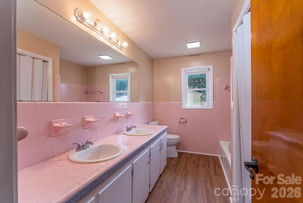 a bathroom with a double vanity sink and a mirror