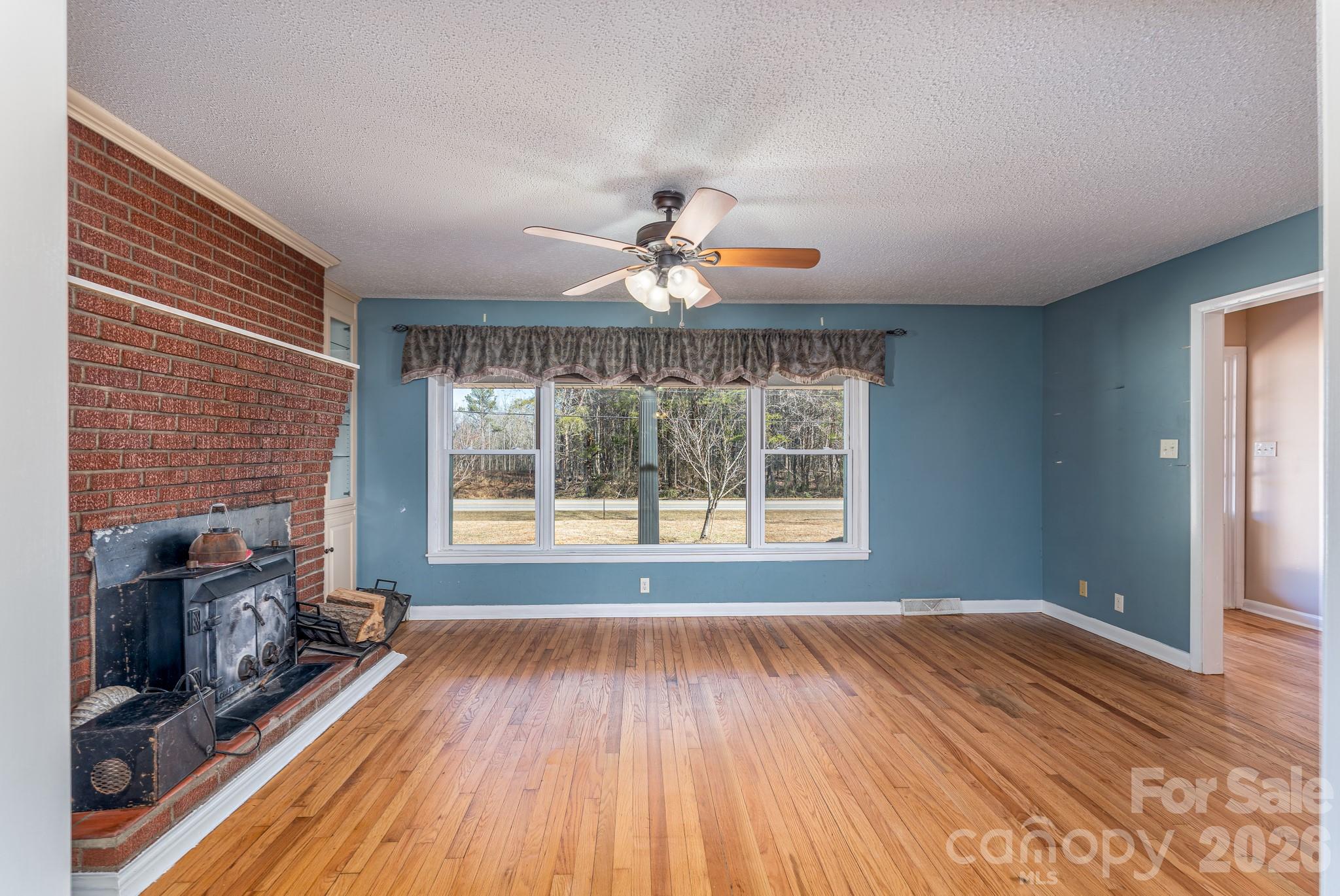 3439 Filbert Highway Clover, SC 29710 - Photo 7 of 28 a view of an empty room with a fireplace and a window