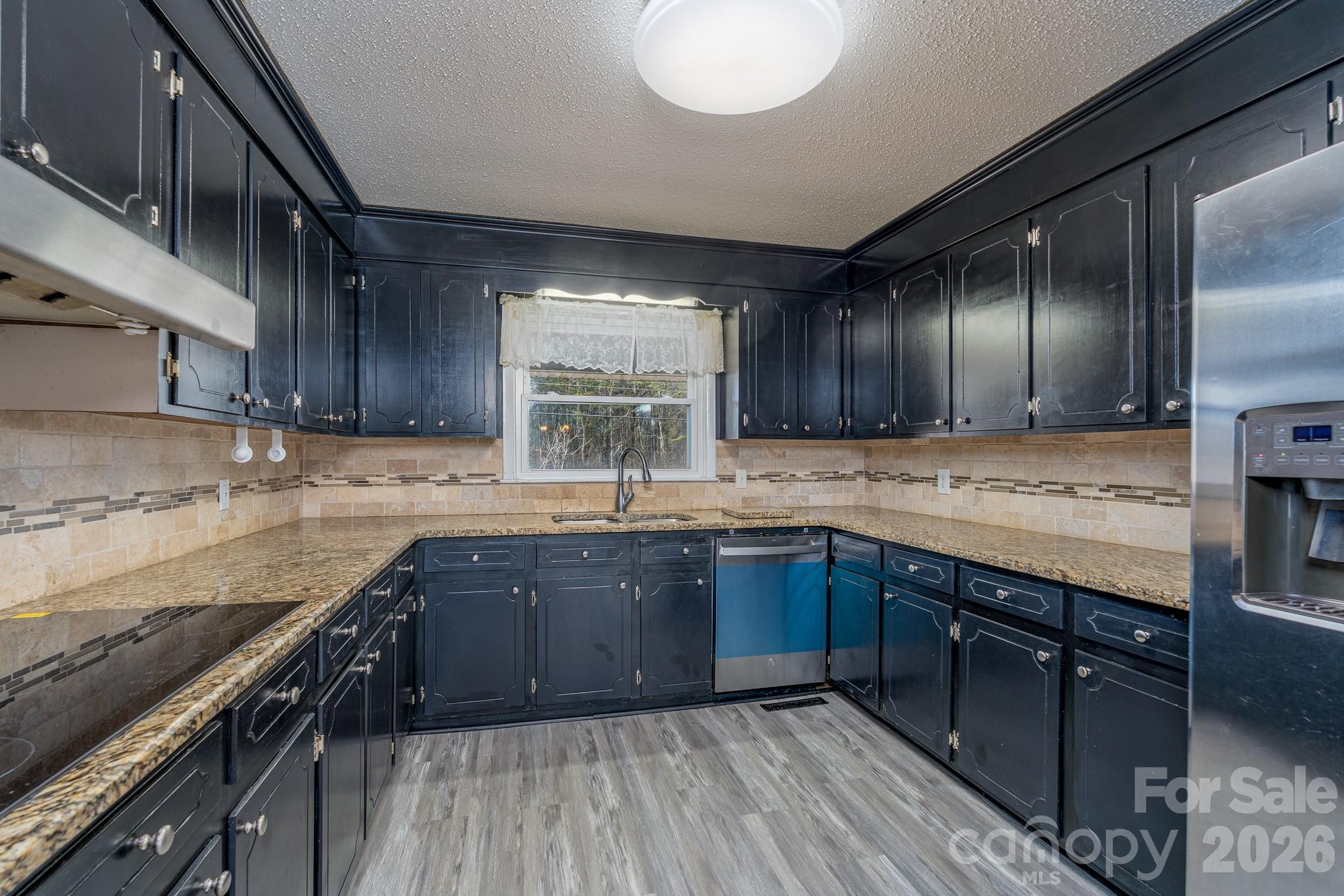 3439 Filbert Highway Clover, SC 29710 - Photo 10 of 28 a kitchen with stainless steel appliances granite countertop wooden cabinets a sink and a stove