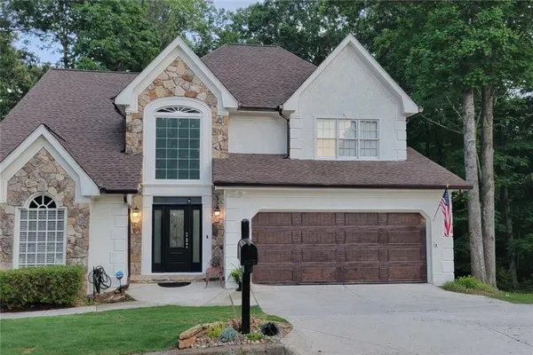 a front view of a house with garden