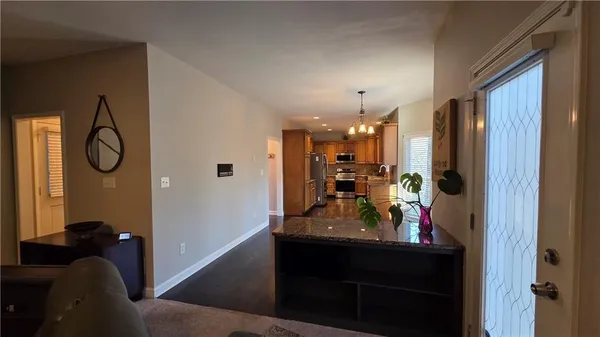 a view of a living room with furniture and wooden floor