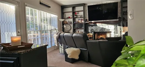a living room with furniture a rug and a window