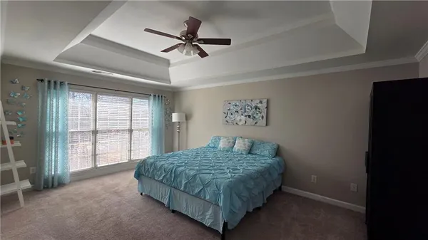 a spacious bedroom with a bed and a dresser