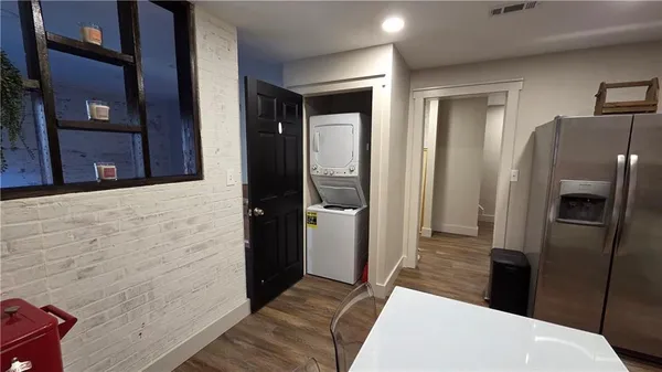 a living room with wooden floor and a window