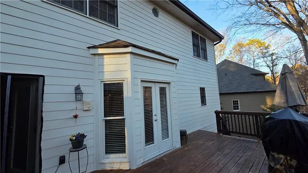 a view of a yard with wooden fence