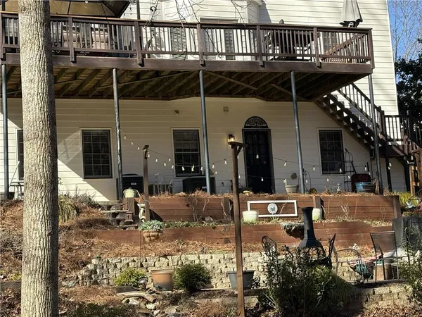 a view of a backyard with plants and outdoor seating