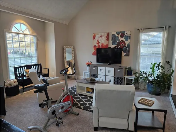 a view of a livingroom with workspace and a window