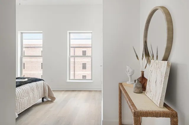 a bedroom with a bed and a window