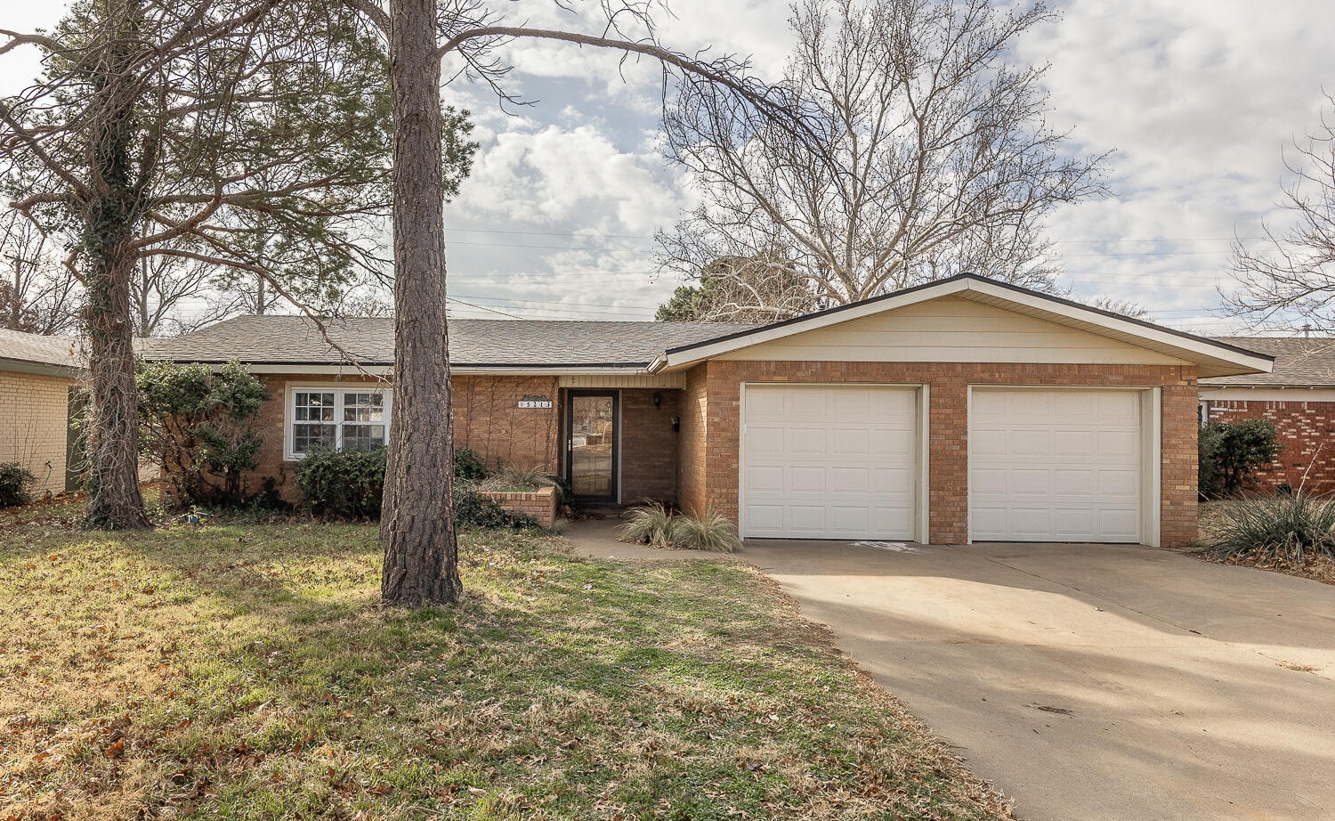 5213 16th Street Lubbock, TX 79416 - Photo 1 of 1 a view of a house with a yard and garage