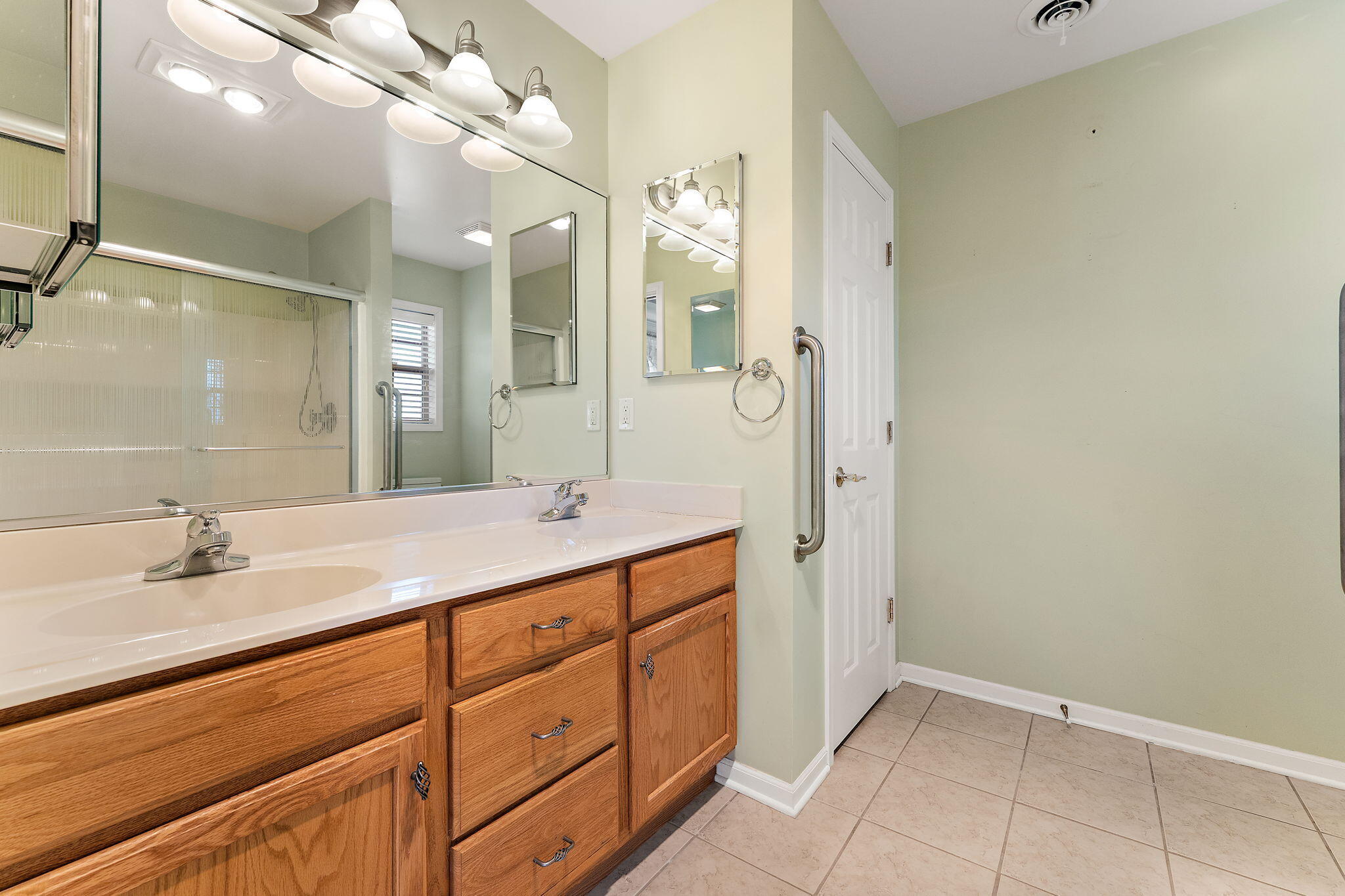 901 Veterans Lane Crown Point, IN 46307 - Photo 19 of 40 a bathroom with a sink vanity and a mirror