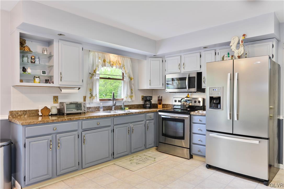 921 Point Phillips Road Bath, PA 18014 - Photo 5 of 29 a kitchen with stainless steel appliances granite countertop a refrigerator sink and stove