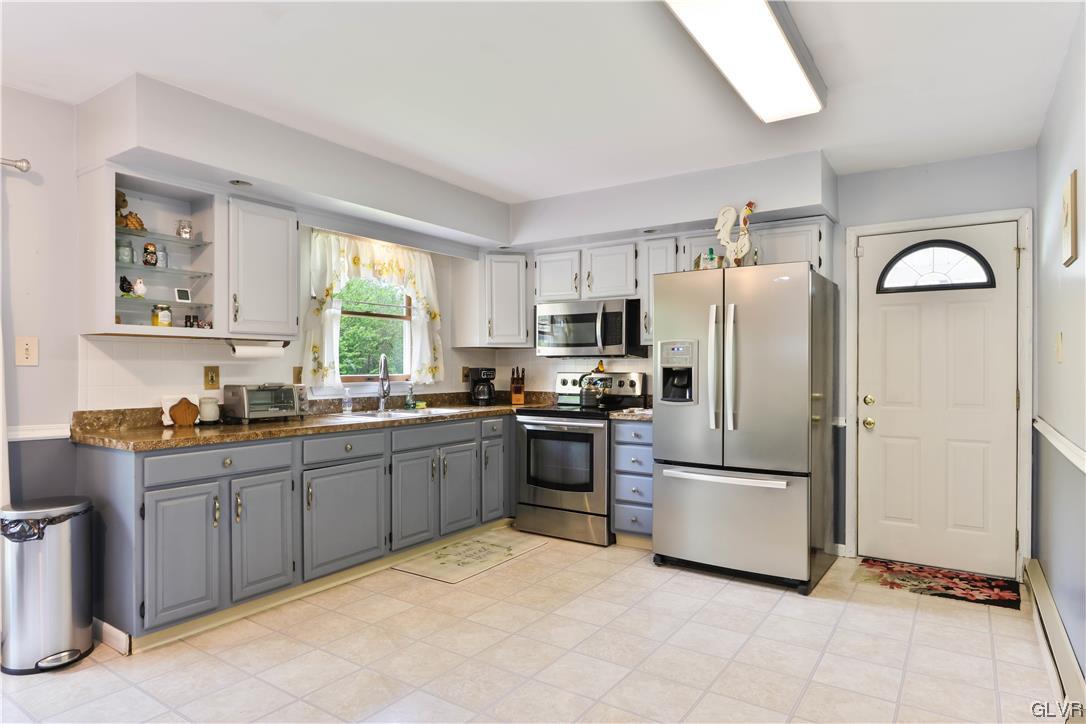 921 Point Phillips Road Bath, PA 18014 - Photo 7 of 29 a kitchen with stainless steel appliances granite countertop a refrigerator sink and stove