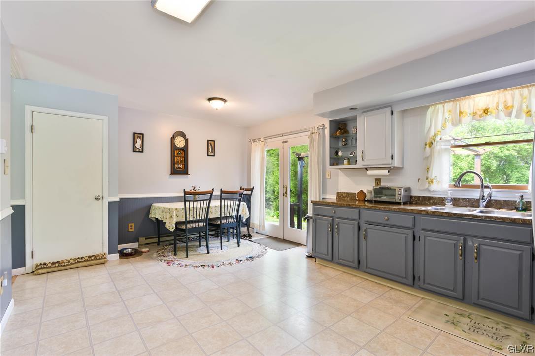 921 Point Phillips Road Bath, PA 18014 - Photo 8 of 29 a kitchen with granite countertop a sink dining table and chairs