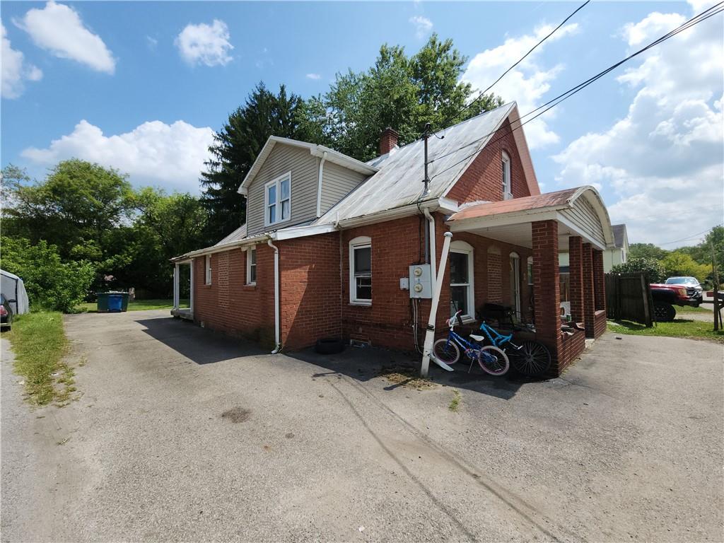 8 Elm Street Bessemer, PA 16112 - Photo 2 of 22 a view of a house with a yard and large trees