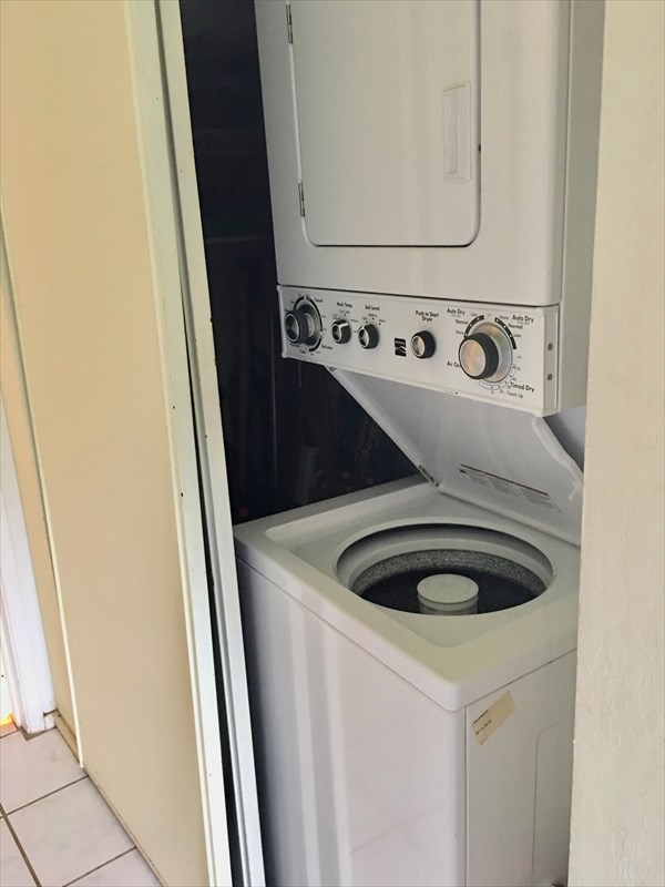 95-789 Ninole Loop Road, Unit 42 Naalehu, HI 96772 - Photo 11 of 17 a utility room with dryer and washer