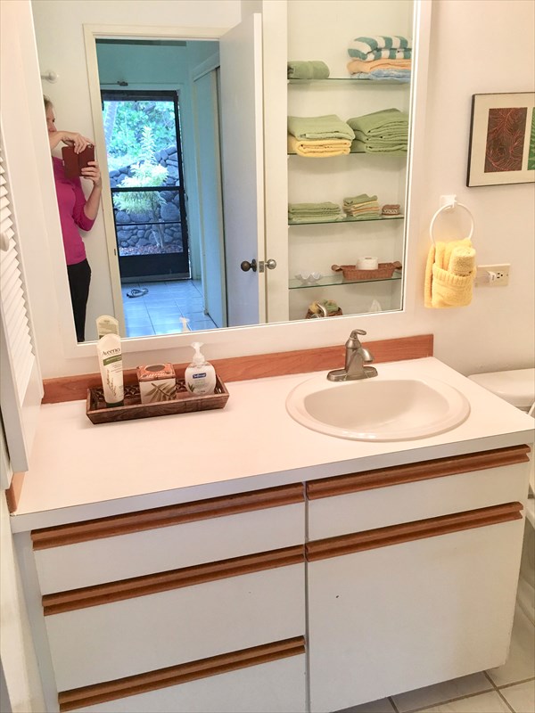 95-789 Ninole Loop Road, Unit 42 Naalehu, HI 96772 - Photo 13 of 17 a bathroom with a sink and a mirror