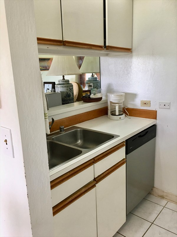 95-789 Ninole Loop Road, Unit 42 Naalehu, HI 96772 - Photo 8 of 17 a kitchen with a sink and cabinets