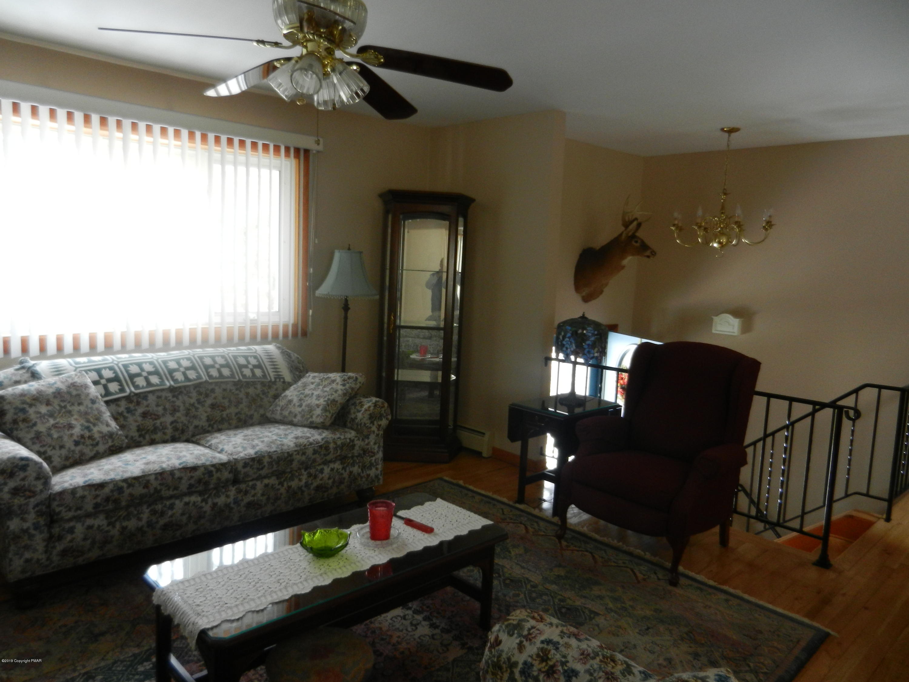 427 Emery Wheel Road Stroudsburg, PA 18360 - Photo 14 of 21 a living room with furniture and a chandelier