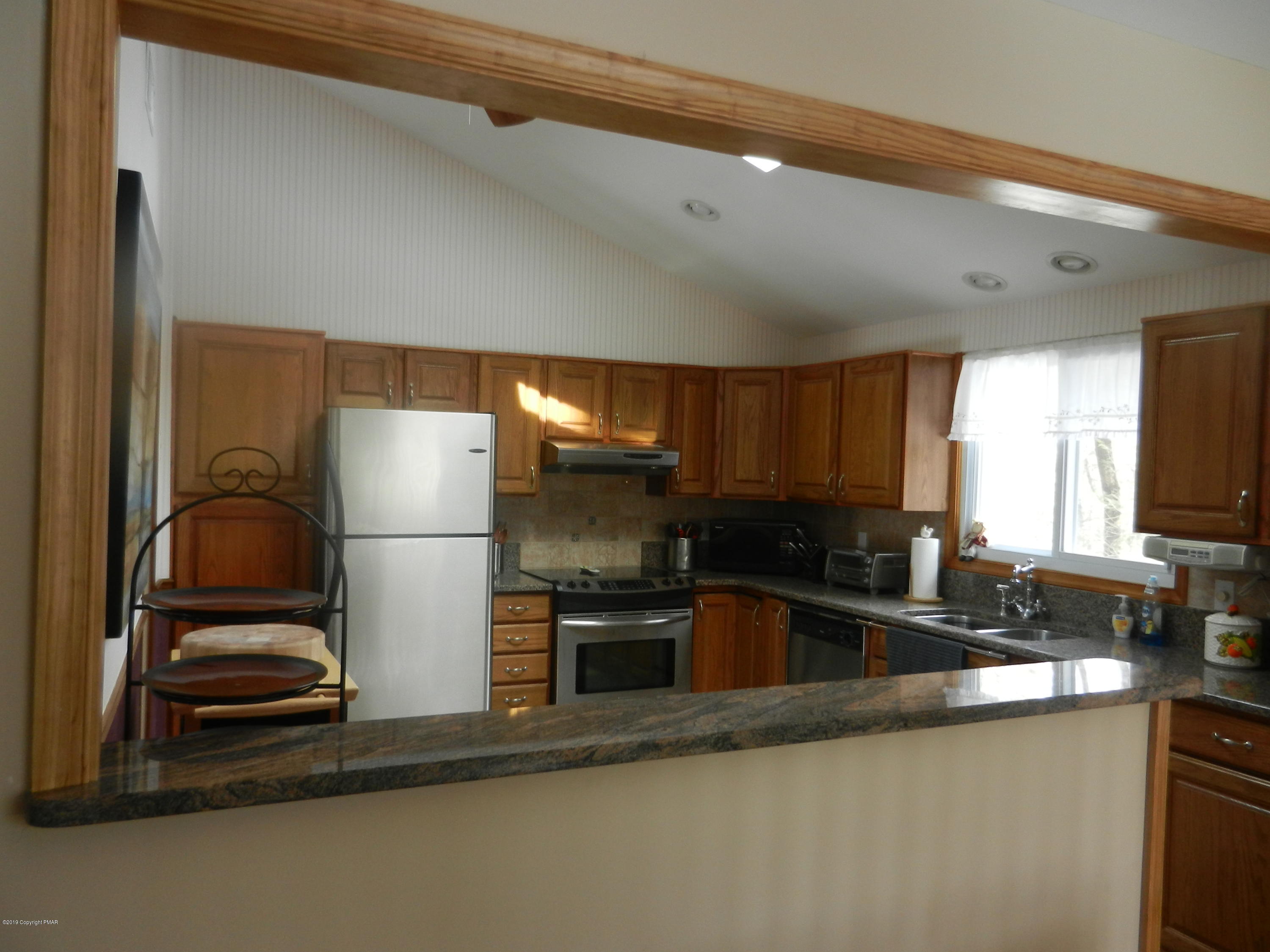 427 Emery Wheel Road Stroudsburg, PA 18360 - Photo 15 of 21 a kitchen with a refrigerator and a sink