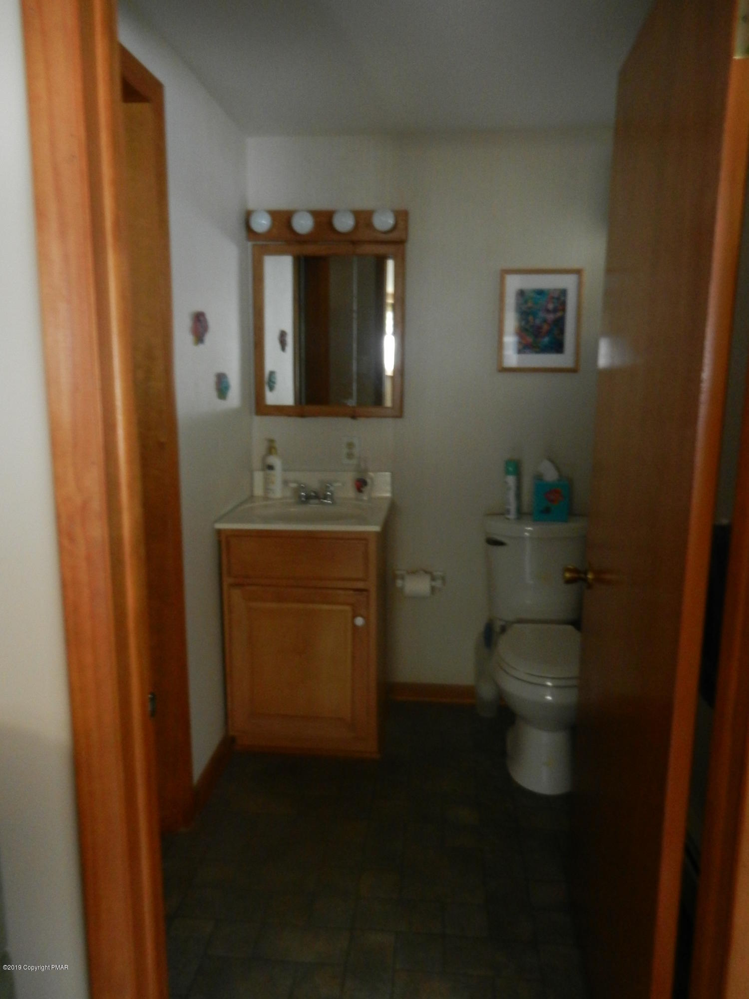 427 Emery Wheel Road Stroudsburg, PA 18360 - Photo 17 of 21 a bathroom with a toilet sink and mirror
