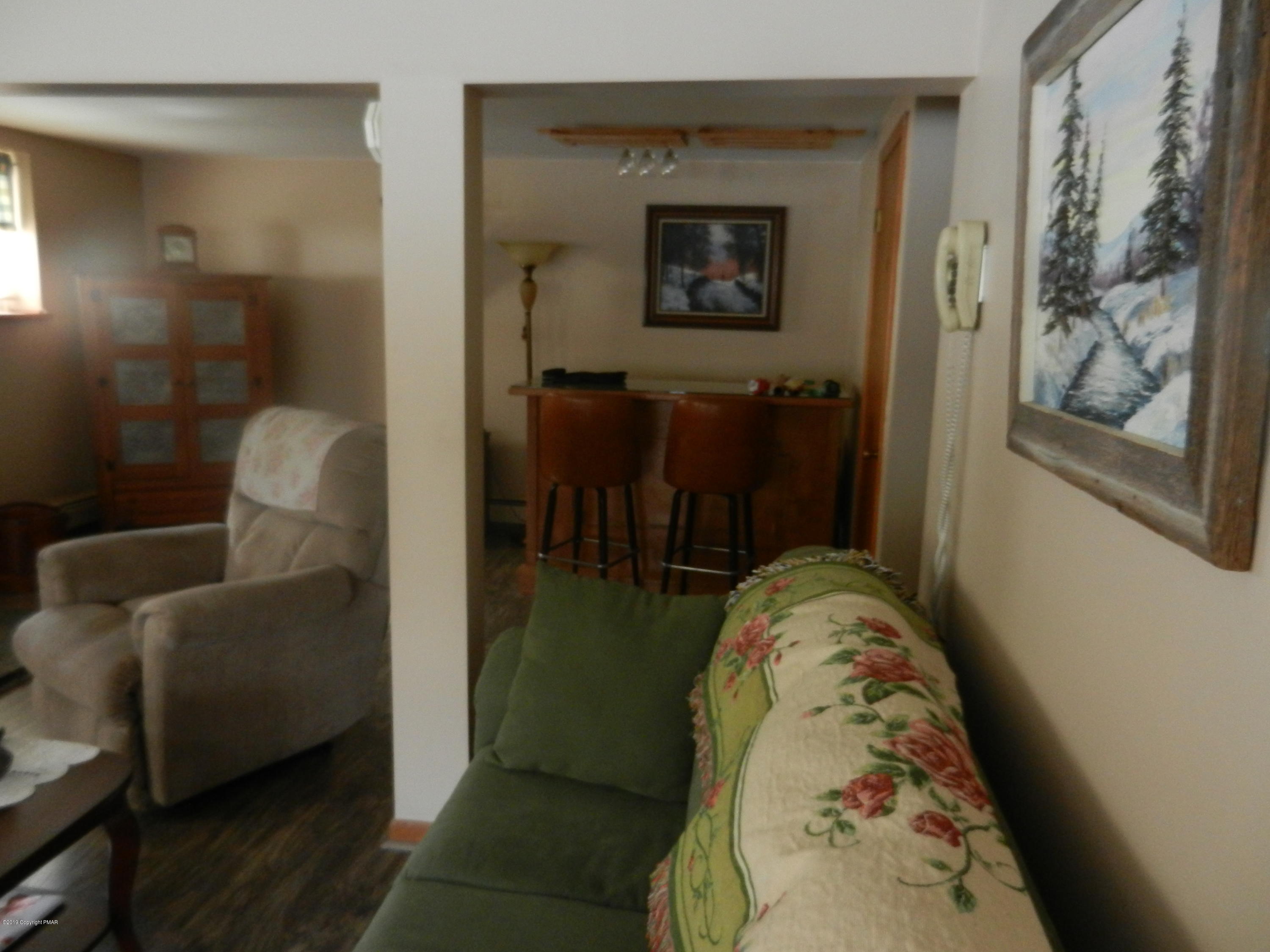 427 Emery Wheel Road Stroudsburg, PA 18360 - Photo 2 of 21 a living room with furniture and a flat screen tv
