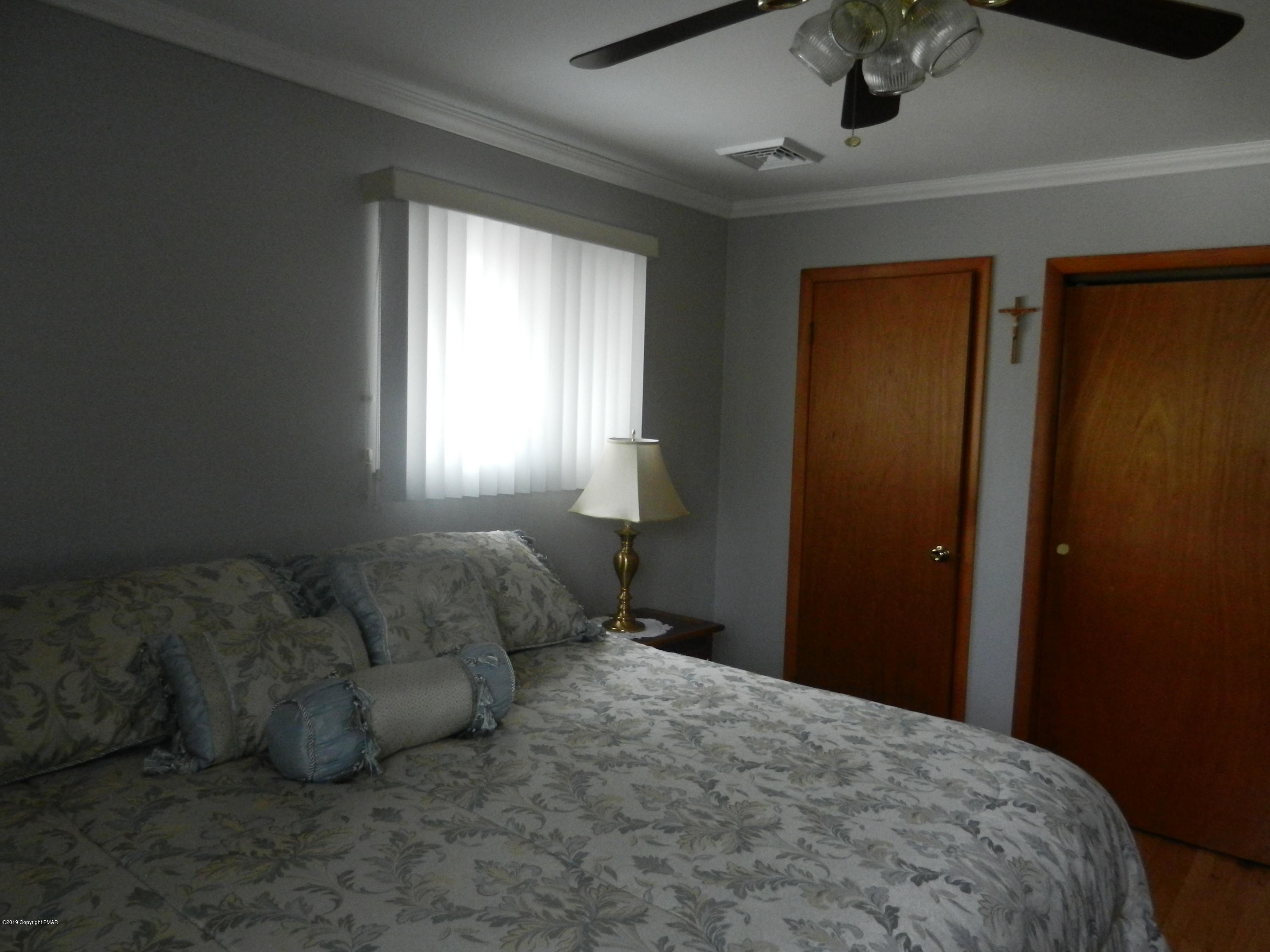 427 Emery Wheel Road Stroudsburg, PA 18360 - Photo 21 of 21 a bed room with a bed and a ceiling fan