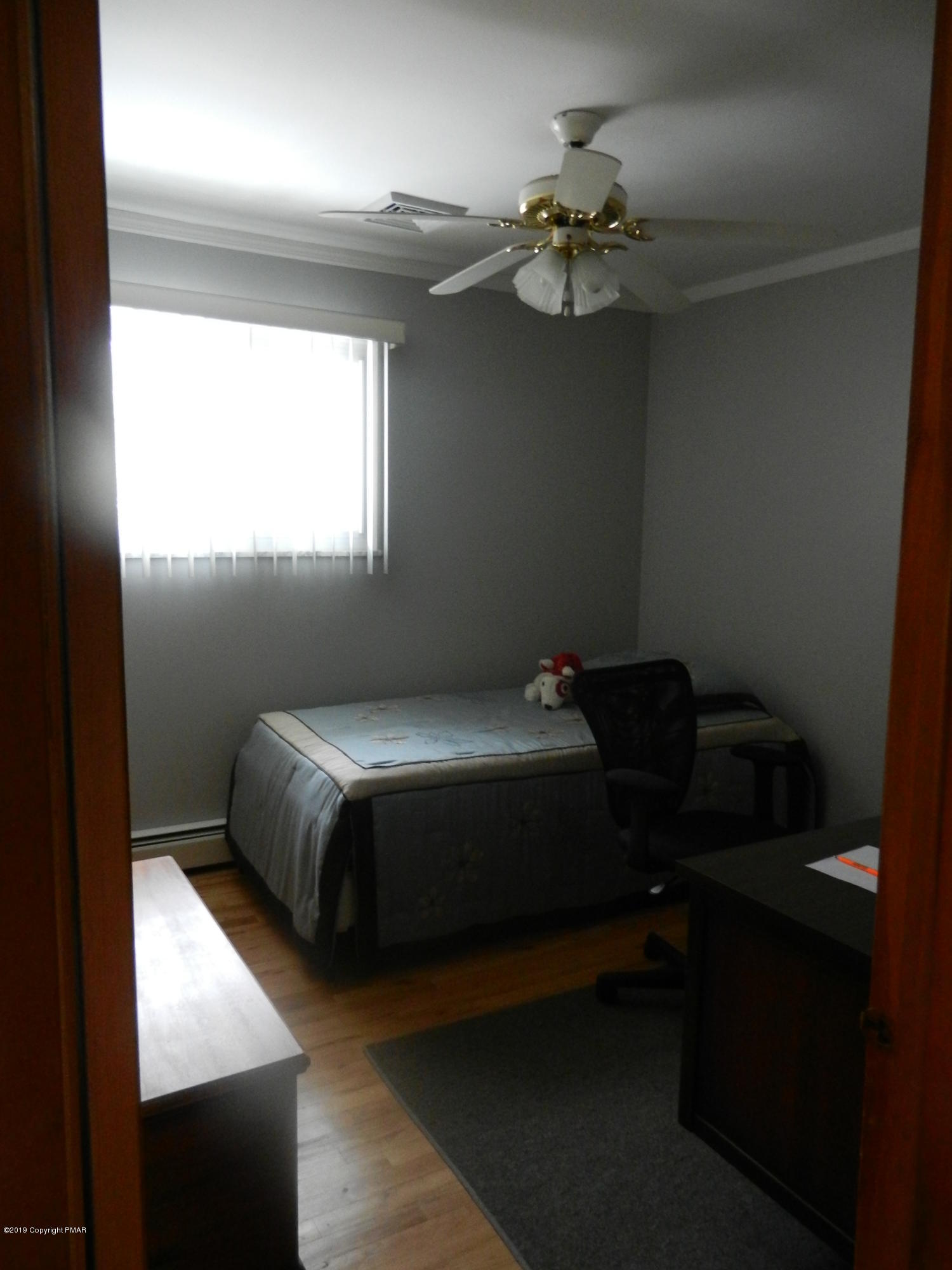 427 Emery Wheel Road Stroudsburg, PA 18360 - Photo 8 of 21 a bedroom with a bed and a chandelier