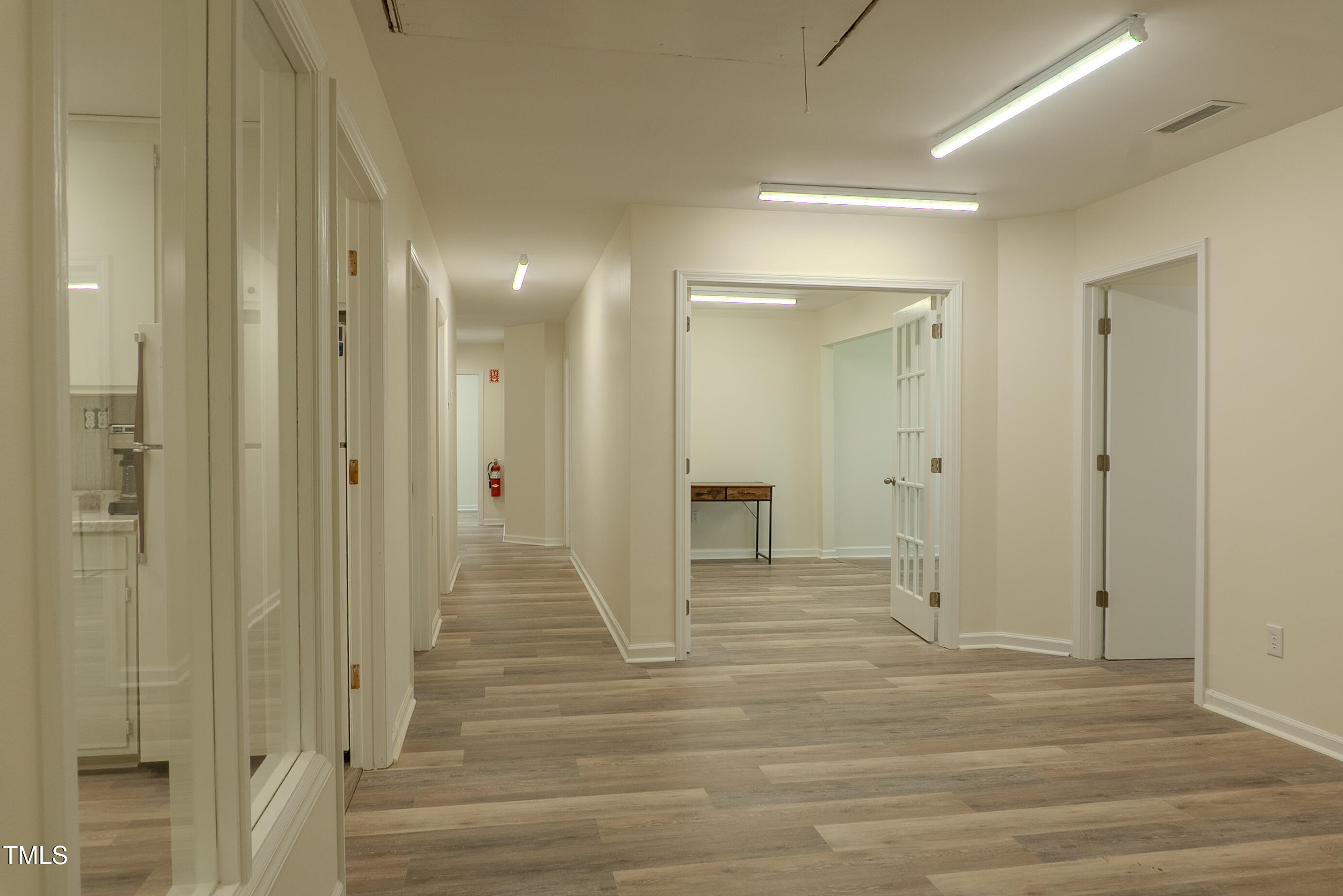 6504 Burlington Road Whitsett, NC 27377 - Photo 14 of 34 a view of a hallway with wooden floor and closet area