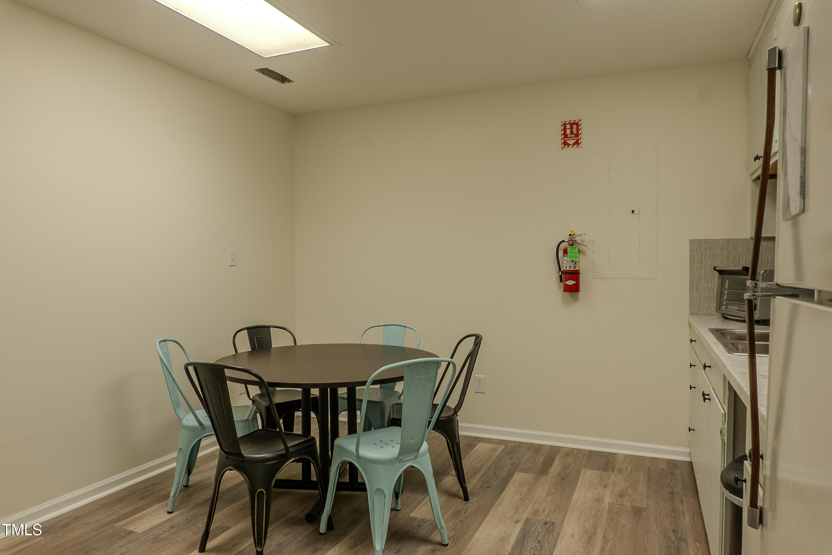 6504 Burlington Road Whitsett, NC 27377 - Photo 15 of 34 a view of a dining room with furniture and wooden floor
