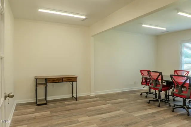 a view of a room with wooden floor and lounge chairs